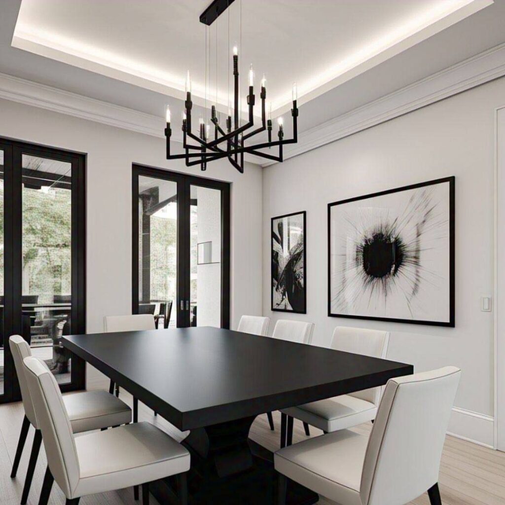 Black dining table and white chairs in a monochrome room with abstract art.