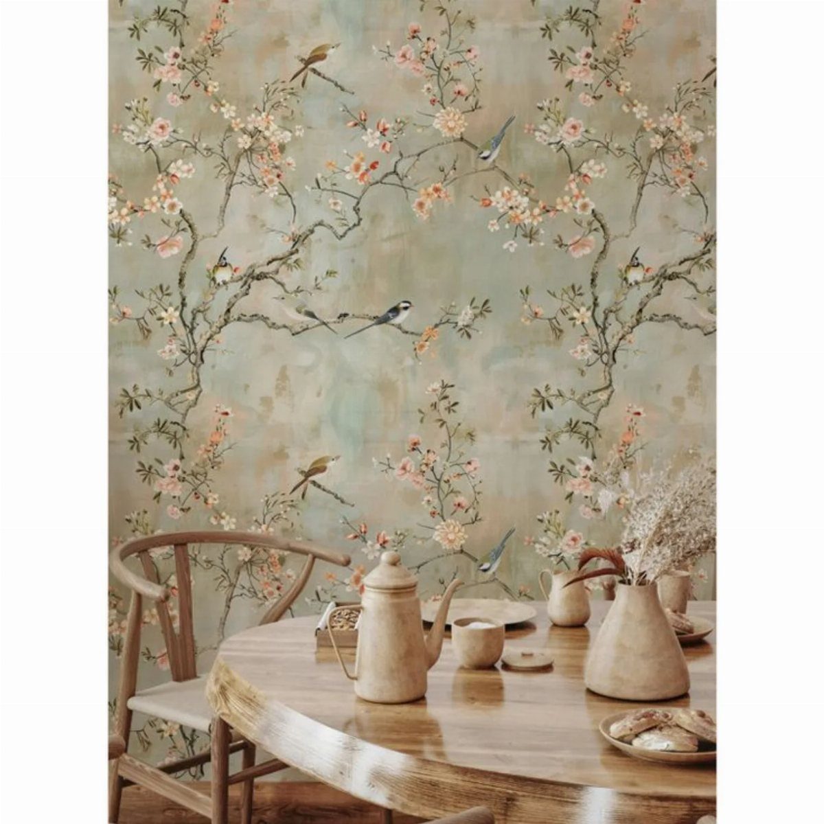 Botanical wallpaper with cherry blossoms and birds behind a wooden dining table and chair.
