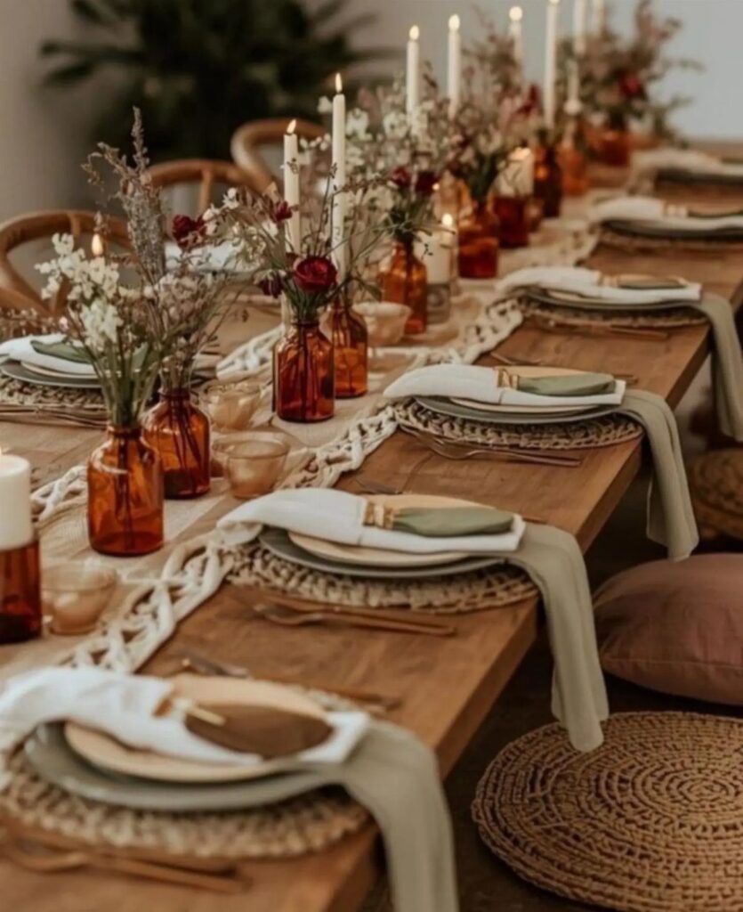 Wooden dining table with macrame runner, amber flower vases, and woven placemats.