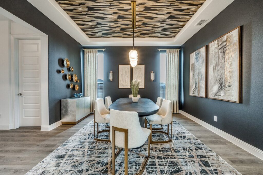 Dining room with a recessed tray ceiling featuring gold and black textured patterns.