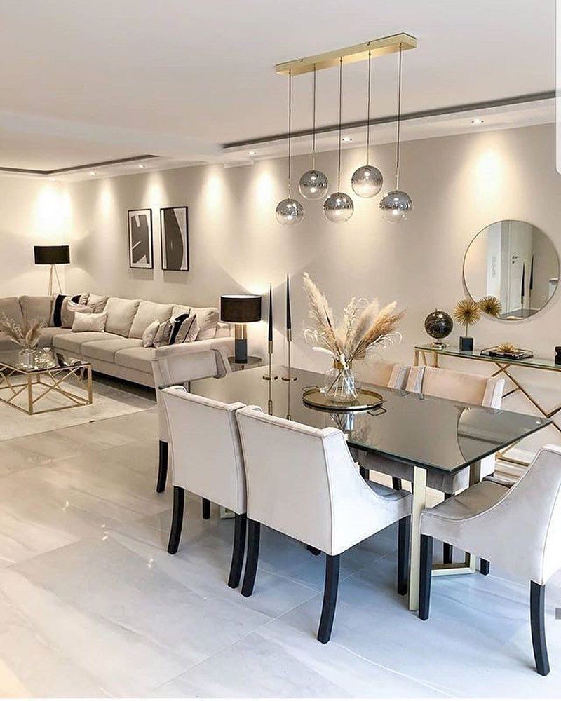 Modern open concept living and dining room with white furniture and marble floors